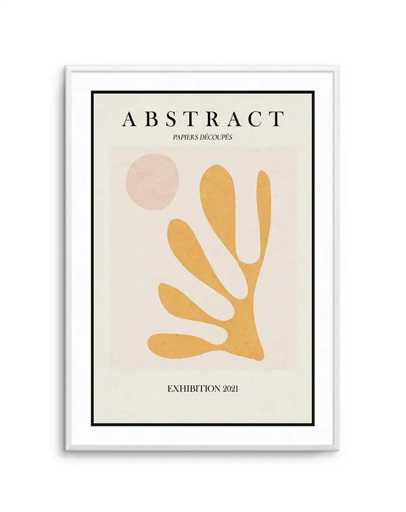 Framed art print titled "Abstract: Papiers Découpés, Exhibition 2021" featuring minimalist cut-paper style design. Cream background with a dusty rose circular shape in upper left and a golden yellow organic hand or plant-like form with elongated fingers below. Black border frame with white frame surround. Serif typography in black at top and bottom.