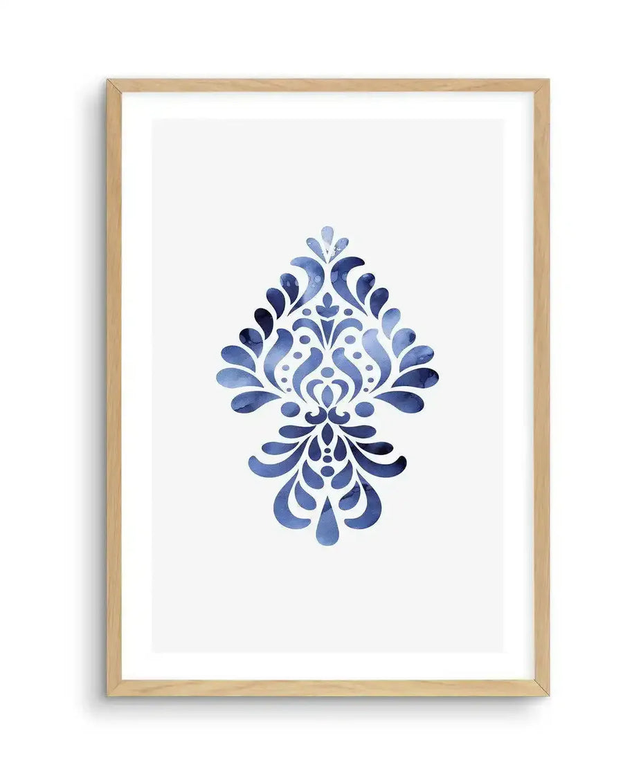Watercolour art print featuring a symmetrical damask-style motif in varying shades of deep and medium blue, with visible brushstroke texture, displayed in a natural oak frame with white border.
