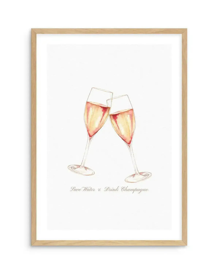 Framed art print featuring a watercolor illustration of two champagne flutes clinking together, filled with pale golden and rose-tinted champagne. The glasses are rendered in soft, translucent watercolor tones with delicate linework. Below the glasses, cursive text reads "Save Water & Drink Champagne." The artwork is displayed in a natural wood frame with a white border against a white background.