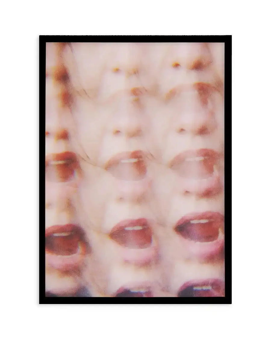Abstract art print featuring a repeating pattern of blurred faces with open mouths, creating a distorted and unsettling composition. The faces are rendered in soft, muted tones of pale pink, peach, and light brown, with hints of red on the lips and subtle dark shadows suggesting depth. The image has a grainy, slightly out-of-focus quality, giving it a dreamlike or distressed texture, and is displayed in a black frame with no border.