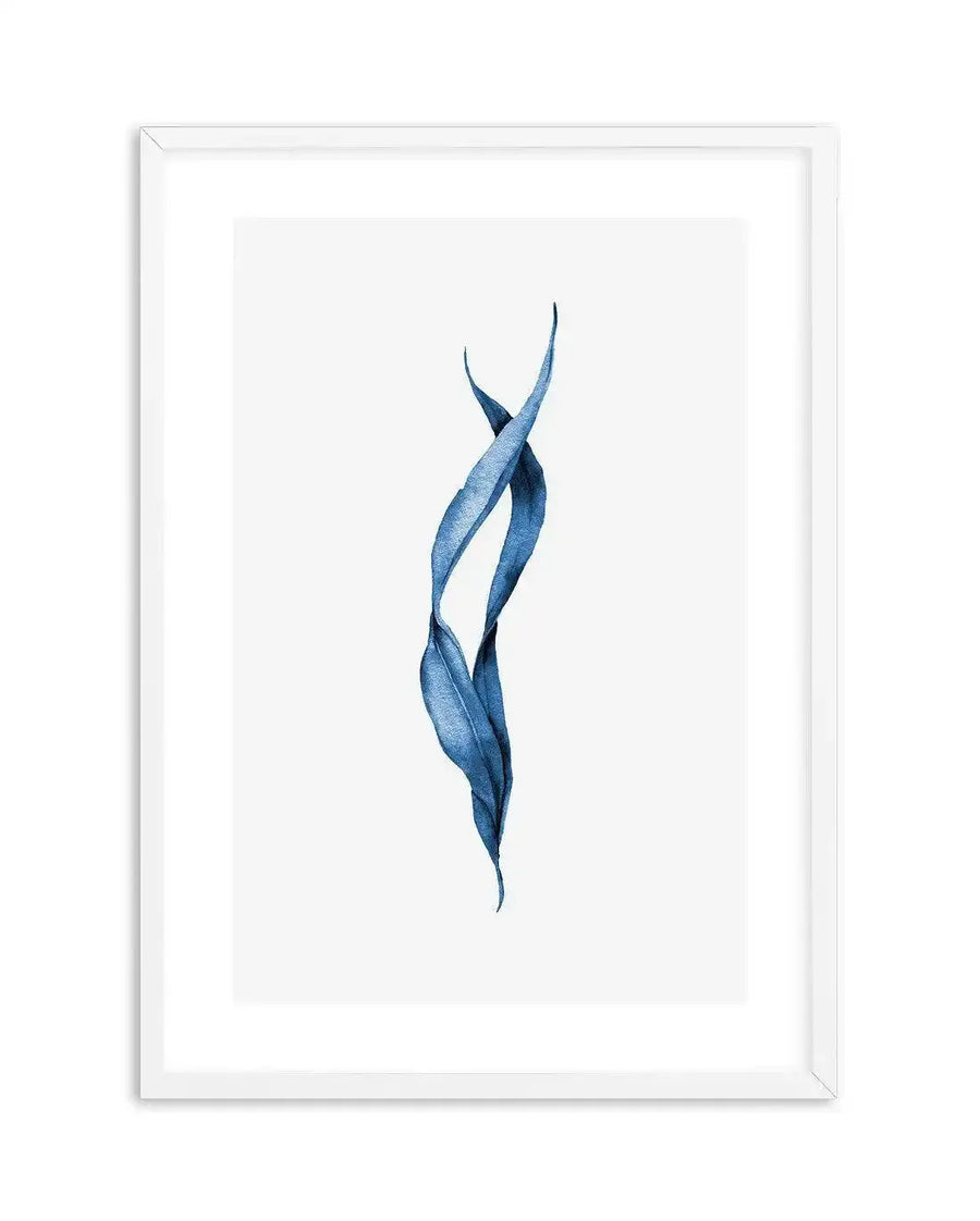 "Watercolour art print featuring two intertwined, elongated leaves in a deep, vibrant blue, suggestive of sea kelp, against a stark white background. The leaves have subtle textural variations and a fluid, organic shape, printed on fine art paper and displayed in a white frame with white border."