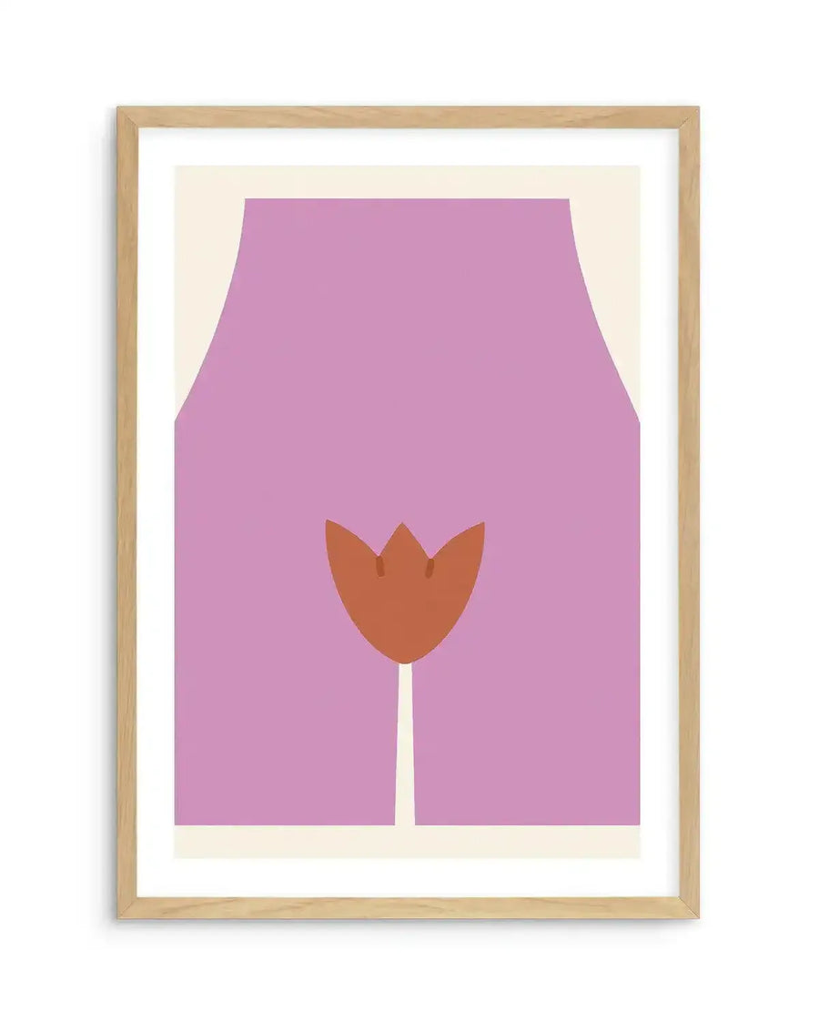 Art print featuring a minimalist illustration of a woman's lower torso and upper thighs in a solid lavender purple, with a stylized reddish-brown tulip shape representing the vulva, printed on fine art paper and displayed in a natural oak frame with white border.