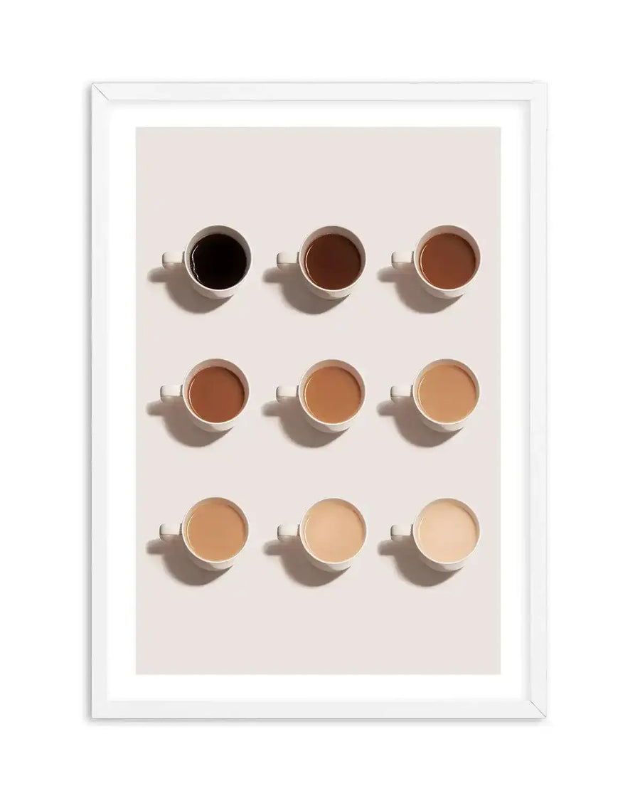 Framed art print featuring nine coffee cups arranged in a 3x3 grid on a light cream background, with a white frame and white border. The cups are filled with coffee in varying shades, from dark black in the top left, gradually lightening to a pale cream in the bottom right, creating a gradient effect.