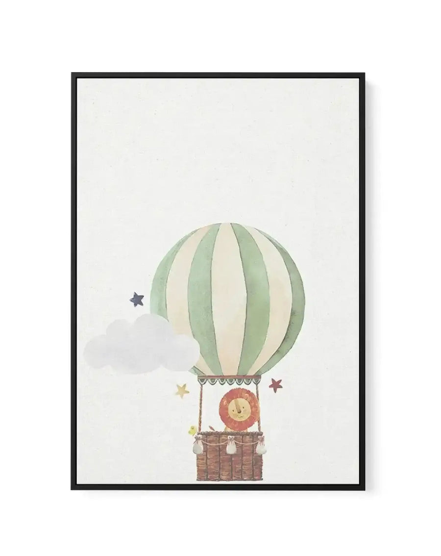 Framed canvas art print featuring a whimsical watercolor illustration of a hot air balloon with alternating sage green and cream vertical stripes. Below the balloon hangs a woven brown basket containing a smiling sun character with a coral-orange face. Scattered around are soft gray clouds and small stars in navy blue, dusty gold, and muted mauve. The artwork is rendered in soft, muted watercolor tones on a cream linen background. The piece is displayed in a black frame with white border.