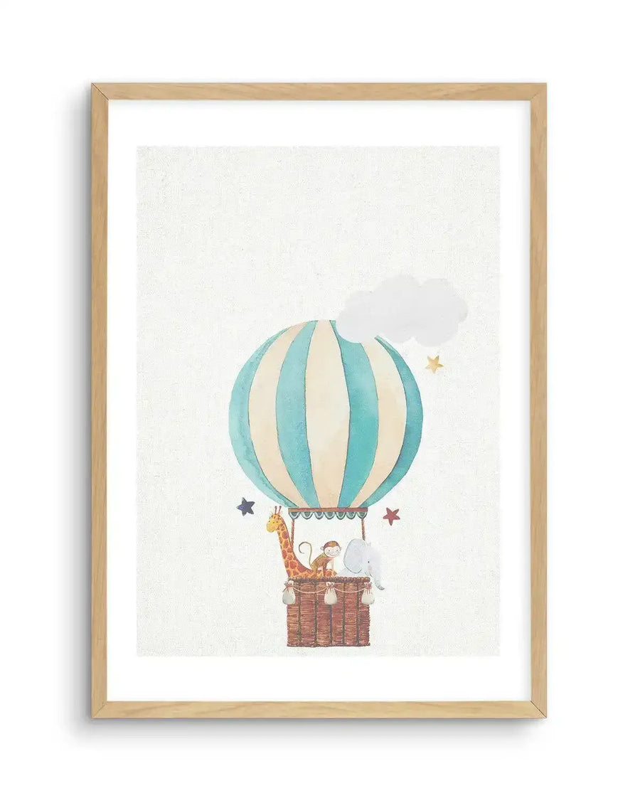 Watercolour art print featuring a hot air balloon with vertical stripes in pale blue and cream, displayed in a natural oak frame with white border. The balloon's wicker basket carries a giraffe, a monkey, and an elephant. A white cloud and golden stars float in the sky.