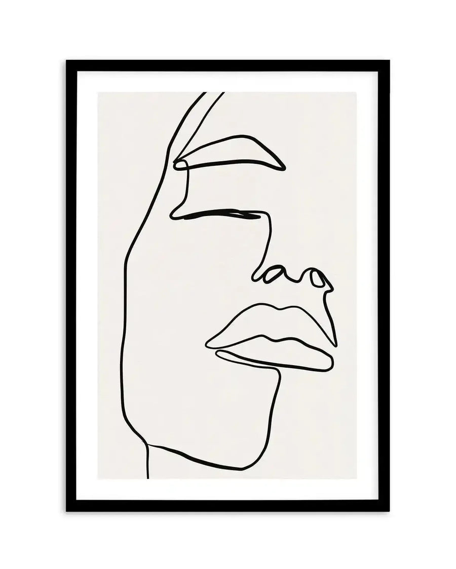 Line art print featuring a minimalist illustration of a woman's face in profile, drawn with a single continuous black line on a white background, displayed in a black frame with white border. The artwork captures the delicate curves of the forehead, closed eye, nose, and full lips, conveying a serene and contemplative mood.