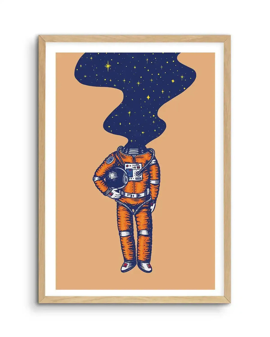 Illustration art print featuring an astronaut in an orange spacesuit with a dark blue, star-filled nebula emerging from the neck opening, displayed in a natural oak frame with white border. The astronaut holds a helmet under their left arm, with visible details on the suit like zippers, pockets, and control panels. The background is a solid light orange-brown.