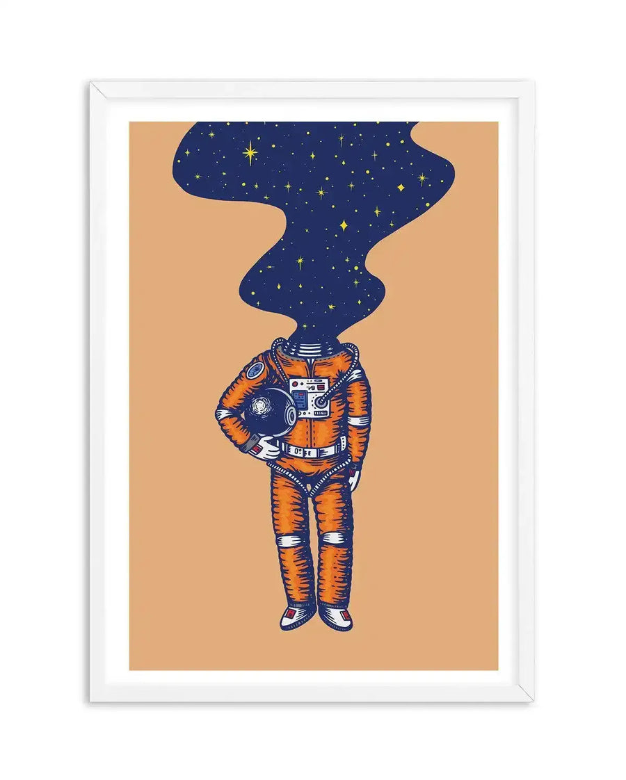 Art print featuring an illustration of an astronaut in an orange spacesuit with a helmet tucked under their left arm, standing against a light orange background. The astronaut's head is replaced by a dark blue, wavy cloud of stars and constellations, suggesting a mind full of space. The illustration has a textured, hand-drawn quality, and the print is displayed in a white frame with a white border.