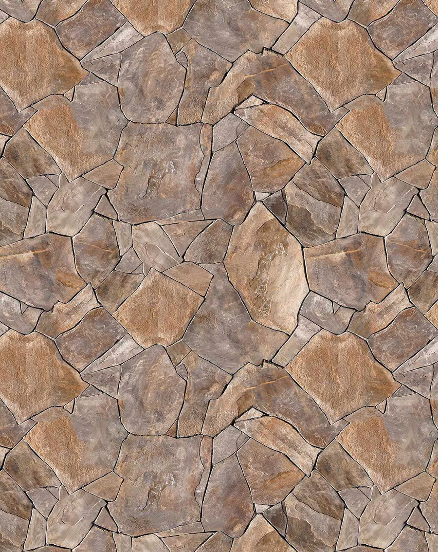 Chalet Wallpaper featuring a seamless pattern of irregular, interlocking stone shapes in warm earth tones including taupe, tan, beige, and soft gray. Each stone tile has dark charcoal grout lines creating distinct separation. The stones display natural texture and subtle color variation with weathered surfaces, suggesting aged fieldstone or slate. The pattern repeats uniformly across the entire surface, creating a realistic stacked stone or flagstone appearance suitable for interior walls.