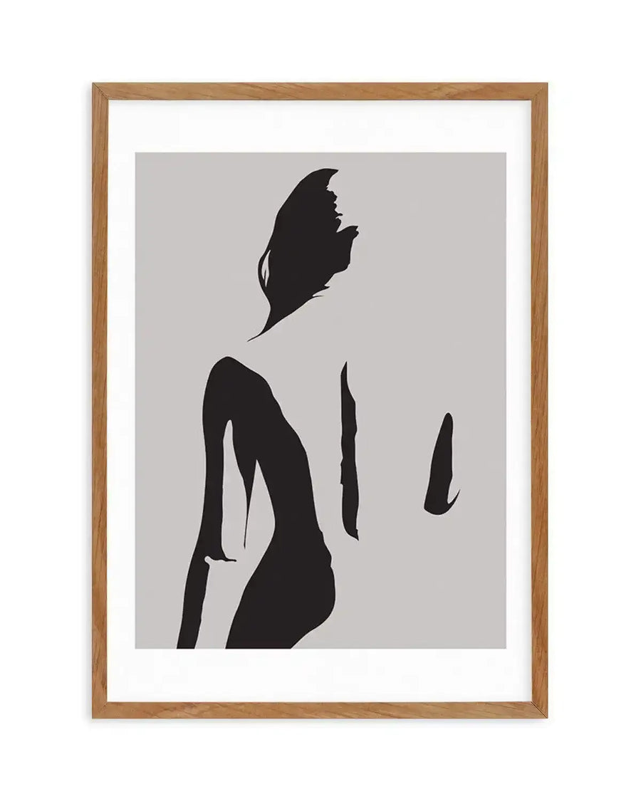 Abstract art print featuring a minimalist silhouette of a female figure in black against a light grey background, with natural wood frame and white border. The figure is depicted from the back, with flowing hair and a curved posture, creating a sense of movement and grace.