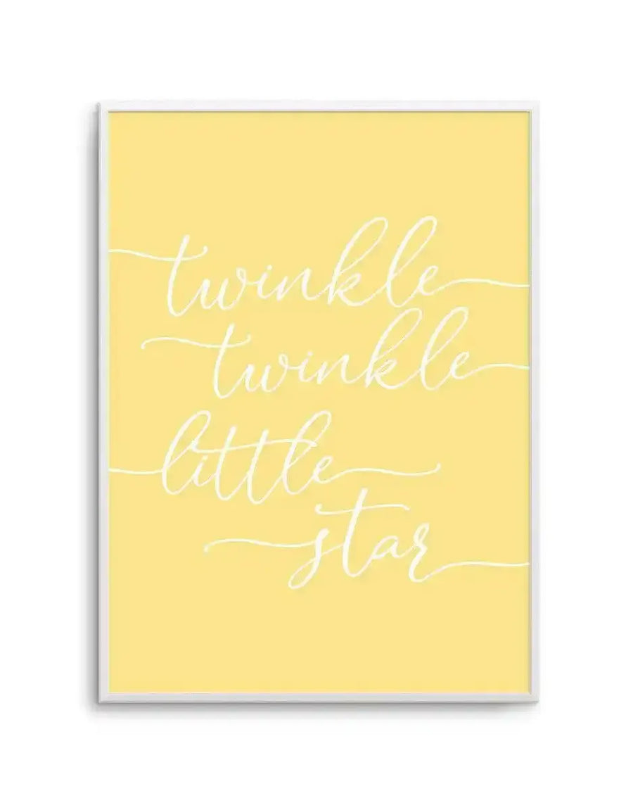 Art print with soft yellow background featuring white handwritten script text reading "twinkle twinkle little star" arranged on four lines with decorative flourishes. The print is displayed in a light gray frame with white border, shown against a white wall.