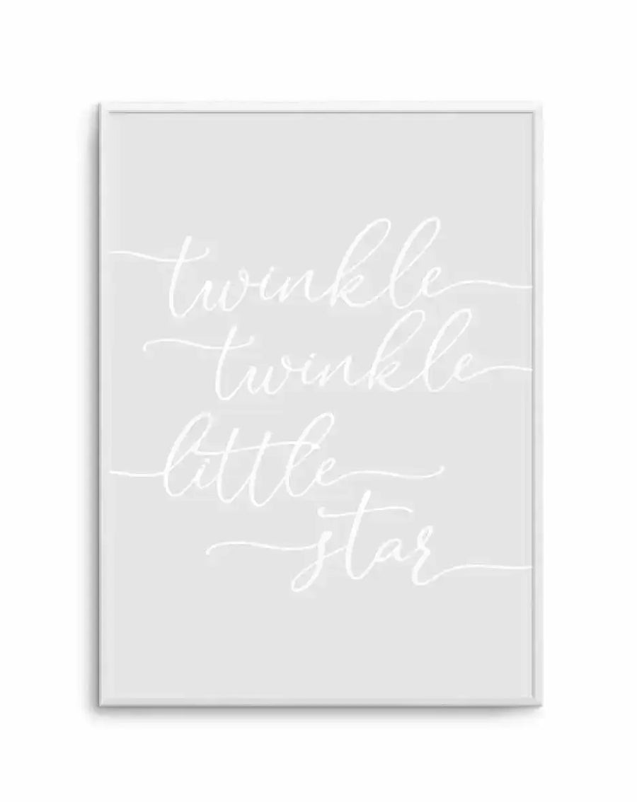 Framed art print featuring the nursery rhyme text "twinkle twinkle little star" written in white cursive script on a soft grey background. The text is arranged in four lines with decorative flourishes extending from the letters. The print is housed in a slim silver-toned frame with a white border. The overall composition has a gentle, calming aesthetic suitable for a child's room.