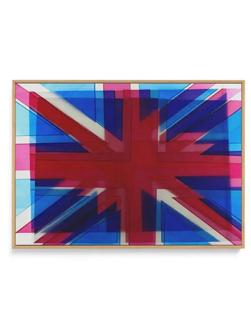 Union Jack Abstract framed canvas art print featuring a geometric interpretation of the British flag with overlapping layers of red, royal blue, navy blue, bright pink, cyan, and cream. The design uses rectangular blocks and diagonal stripes creating a modern, fragmented effect with translucent layering. Natural wood frame with horizontal orientation displayed against white background.