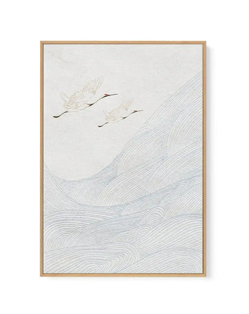 Canvas art print featuring two white cranes with red heads flying over a landscape of rolling hills depicted with light blue wavy lines, all on a textured white background, displayed in a natural wood frame.