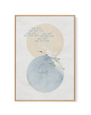 Framed canvas art print featuring two overlapping circles in soft beige and muted blue-grey tones against a cream background. Two white cranes with long dark legs fly upward between the circles. The upper circle contains a pattern of small curved lines suggesting rainfall or water ripples. Natural wood frame with white border. Minimalist, serene aesthetic with watercolor-like painting style and subtle texture throughout.