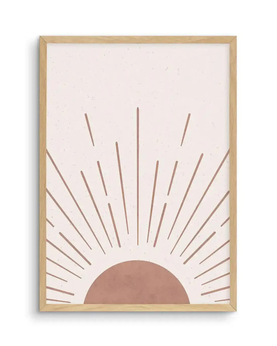 Vintage art print featuring a minimalist illustration of a rising sun with a semi-circle in a muted terracotta hue at the bottom, emitting straight, dashed rays in the same colour against a textured, light cream background. The print is displayed in a natural oak frame with a white border.