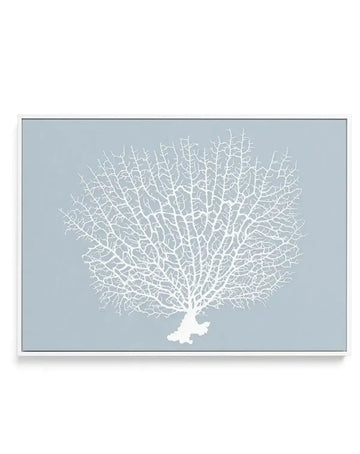 Framed canvas art print featuring a stylized white coral branch against a soft dusty blue background. The coral displays intricate, delicate branching patterns radiating outward in a fan-like formation. The design uses a minimalist illustration style with fine white linework. The canvas is set in a slim gray frame with a white border, displayed as a horizontal rectangular composition.