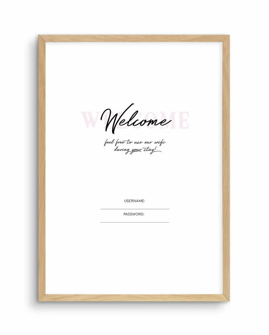 Art print in natural wood frame featuring elegant black script typography on white background. Large "Welcome" text in flowing cursive at center, with smaller handwritten-style subtitle reading "feel free to use our wifi during your stay!" Below are two blank lines labeled "USERNAME:" and "PASSWORD:" in sans-serif font. Soft watermark text reading "WIFI" visible in background. Natural wood frame with warm honey tone and simple rectangular profile. White border between artwork and frame edge.