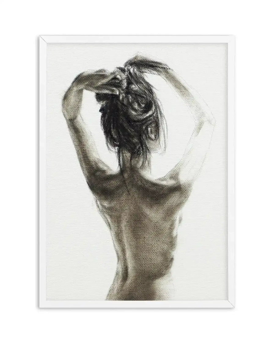 Charcoal art print featuring a woman viewed from the back, with her arms raised to tie up her hair. The artwork has visible charcoal texture and shading, creating a sense of depth and form against a white background, displayed in a white frame with a white border.