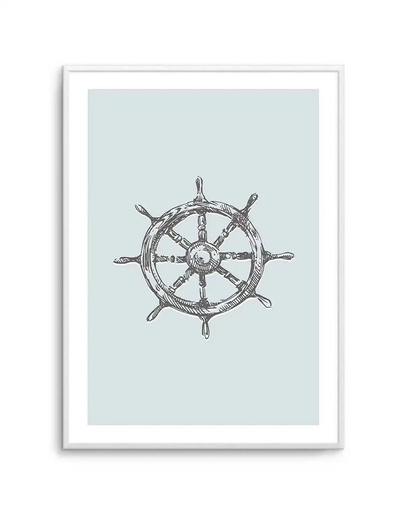 Art print featuring a hand-drawn illustration of a ship's wheel in dark grey on a pale blue background, printed on fine art paper and displayed in a white frame with white border.