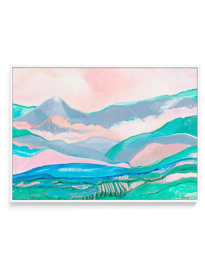 "Gallery-wrapped canvas print of an abstract landscape painting featuring rolling hills and mountains in layers of soft pink, pale blue, and various shades of green and teal. The foreground shows fields with rows of trees, and a body of water in bright blue, all under a light pink and white sky. The painting has a loose, expressive brushstroke quality and is displayed in a thin white frame."